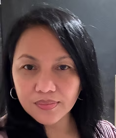 Headshot of a female psychiatrist with long black hair and hoop earrings